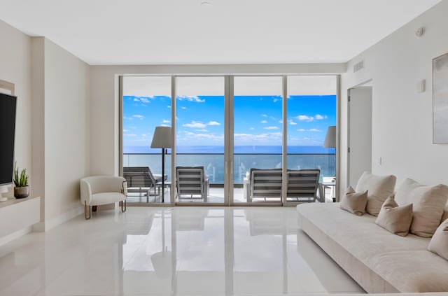 tiled living room featuring a water view