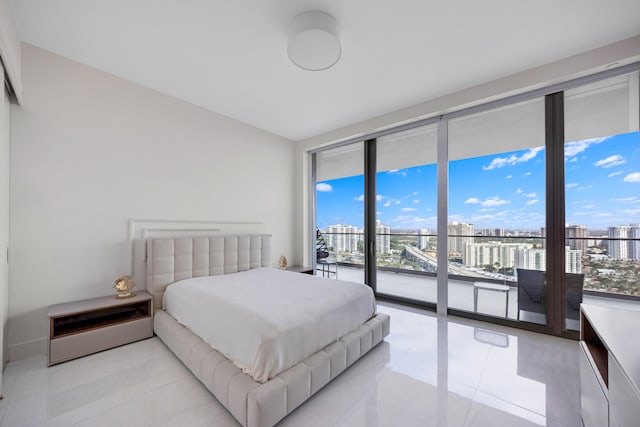 bedroom featuring light tile patterned floors and access to outside