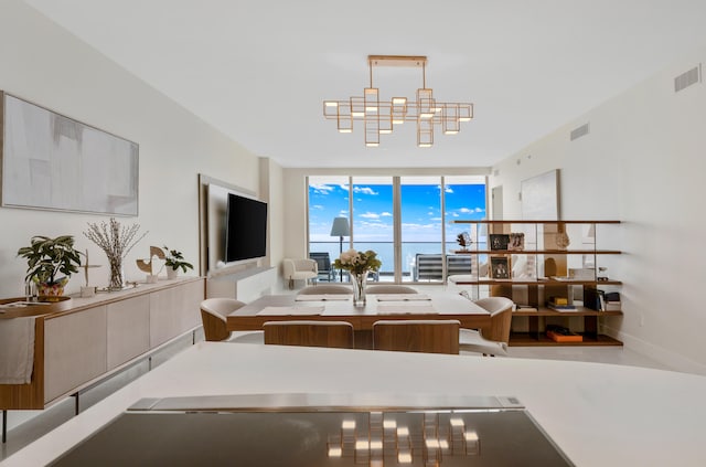 dining room featuring an inviting chandelier and floor to ceiling windows