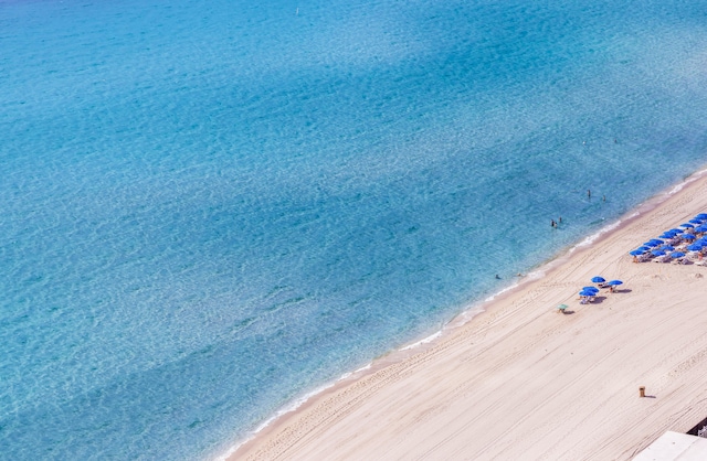 aerial view featuring a view of the beach and a water view