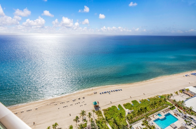 birds eye view of property featuring a water view and a beach view