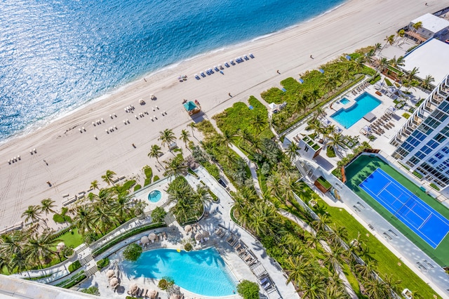 bird's eye view with a water view and a beach view