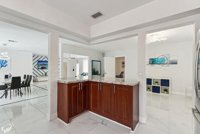 kitchen with visible vents, light stone countertops, and marble finish floor