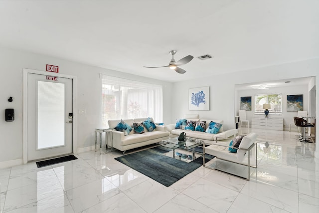 living area with visible vents, marble finish floor, a ceiling fan, and baseboards