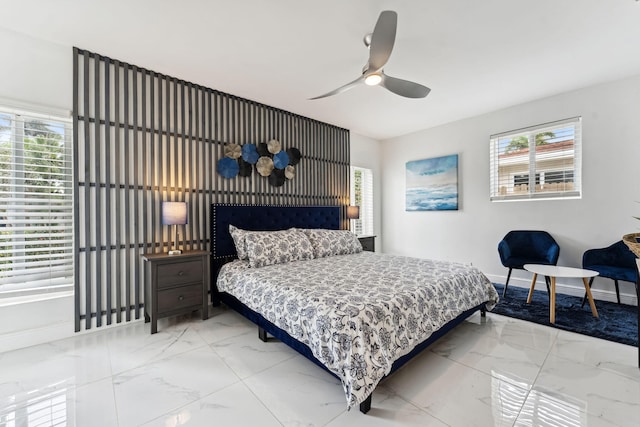 bedroom with baseboards, marble finish floor, and ceiling fan