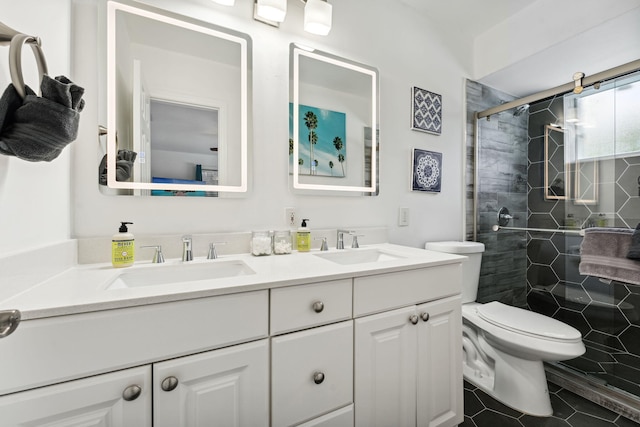 bathroom with tile patterned floors, a stall shower, toilet, and a sink