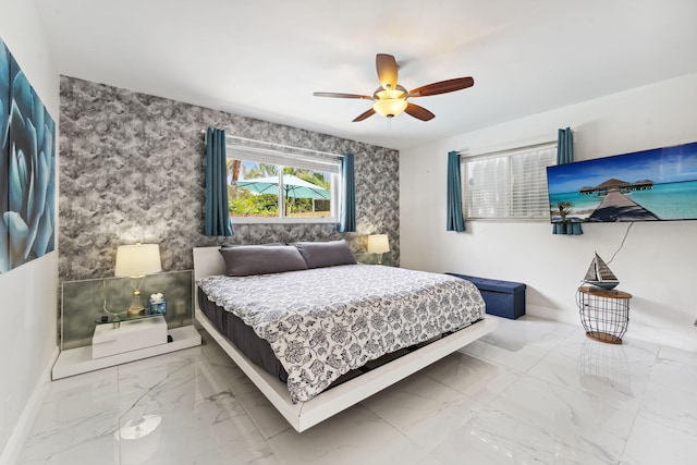 bedroom with baseboards, marble finish floor, ceiling fan, and wallpapered walls