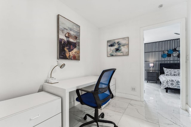 office space with marble finish floor and baseboards