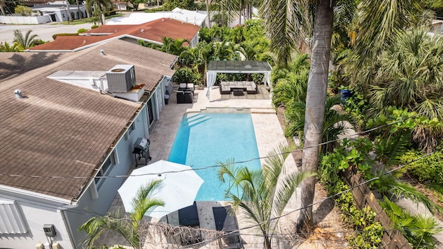 view of swimming pool with a pergola, fence, cooling unit, a fenced in pool, and an outdoor hangout area