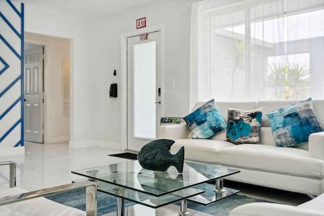 living room with baseboards and marble finish floor