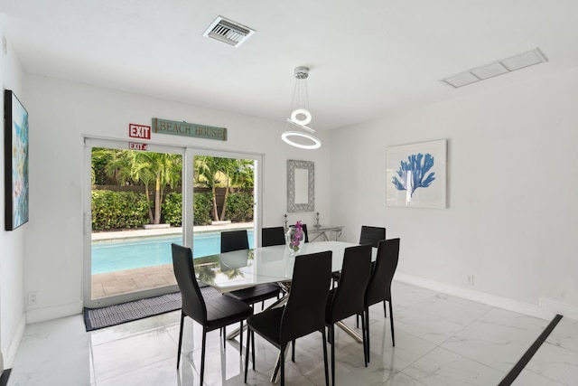 dining room featuring visible vents, baseboards, and marble finish floor