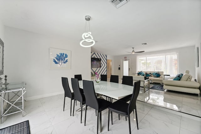 dining area featuring visible vents, baseboards, marble finish floor, and ceiling fan