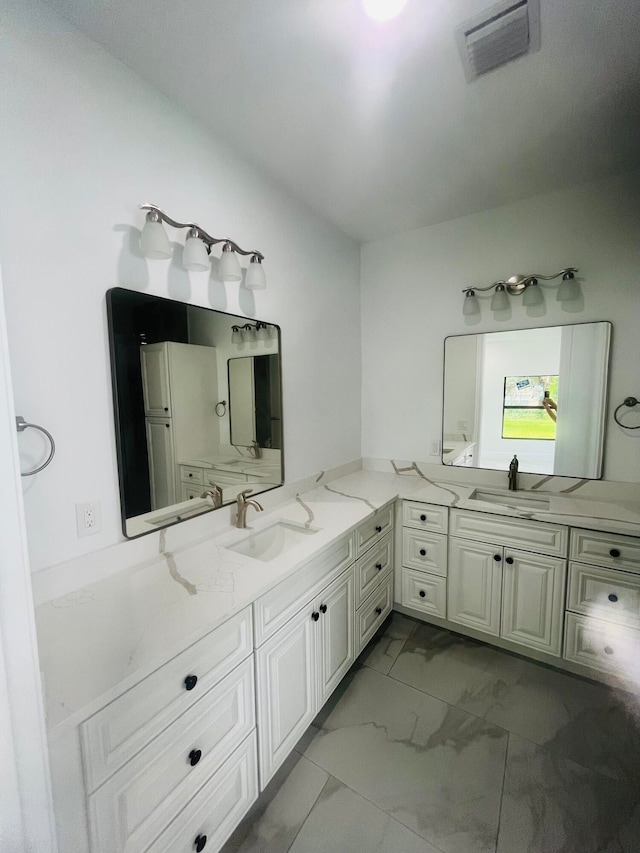 bathroom with dual vanity and tile patterned floors