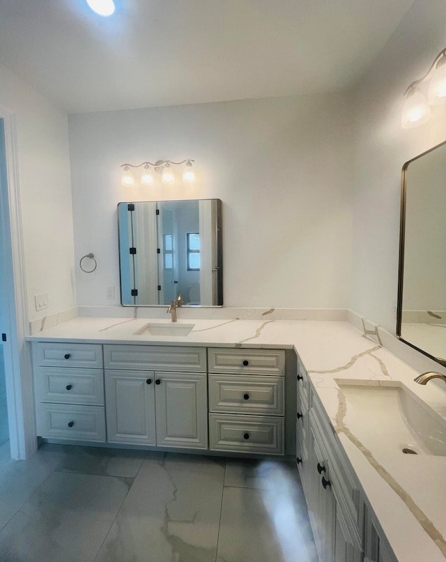 bathroom with tile patterned floors and vanity