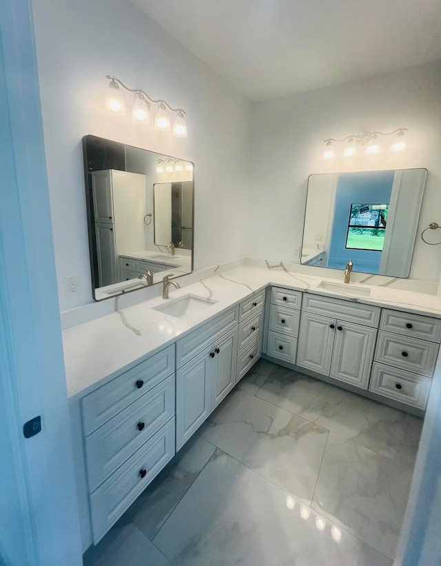 bathroom with tile patterned floors and dual bowl vanity