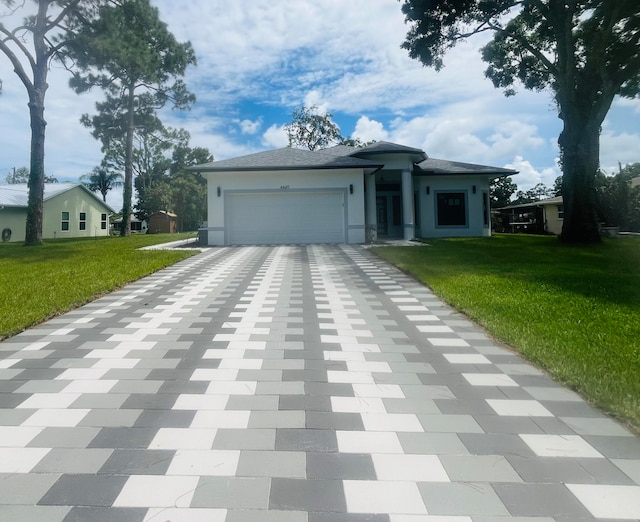 view of front of property with a garage and a front yard