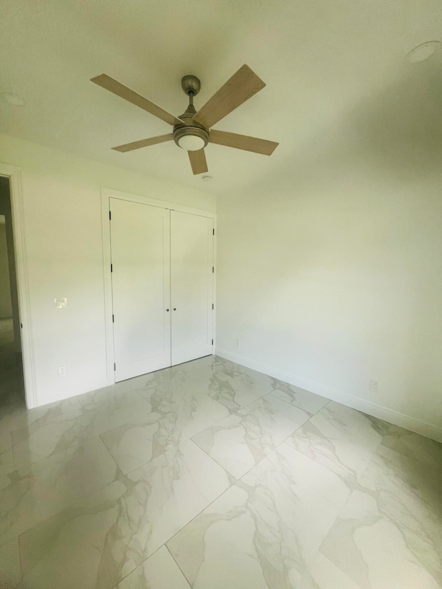 unfurnished bedroom with ceiling fan, tile patterned floors, and a closet