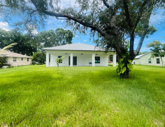 back of house with a lawn