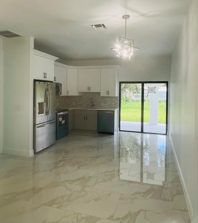 kitchen with tasteful backsplash, stainless steel appliances, white cabinets, sink, and light tile patterned flooring