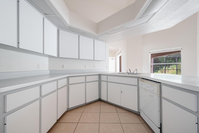 kitchen with dishwasher, light tile patterned floors, and white cabinets