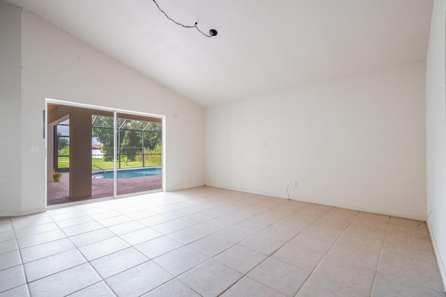 tiled spare room with high vaulted ceiling