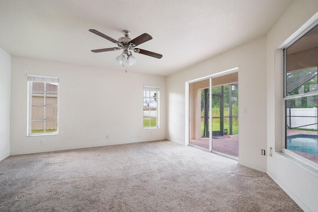 carpeted empty room featuring ceiling fan