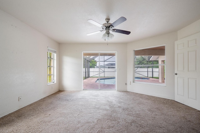 carpeted empty room with ceiling fan