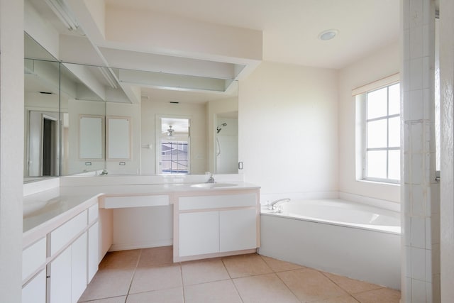 bathroom with tile patterned floors, separate shower and tub, and vanity