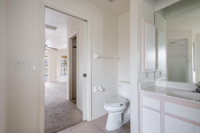 bathroom featuring vanity, toilet, ceiling fan, and tile patterned floors