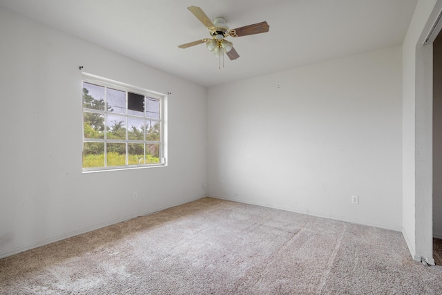 empty room with ceiling fan and carpet floors