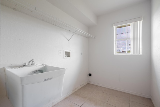 washroom featuring washer hookup and light tile patterned flooring