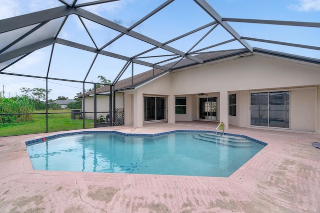 view of swimming pool featuring a lanai and a patio