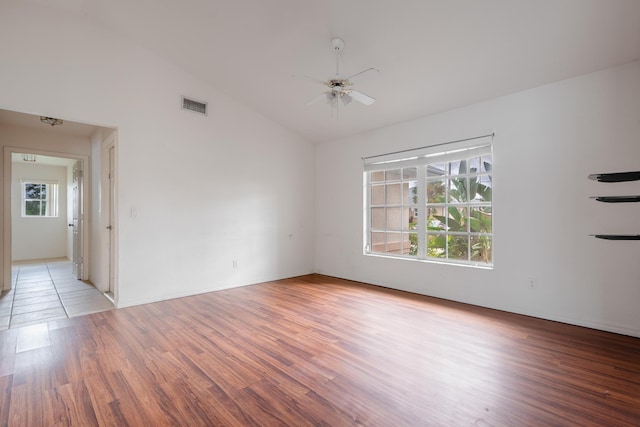 spare room featuring light wood-type flooring, ceiling fan, and lofted ceiling