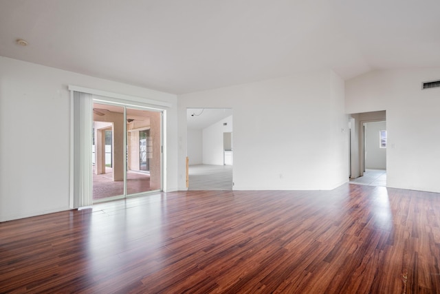 spare room with vaulted ceiling and hardwood / wood-style flooring