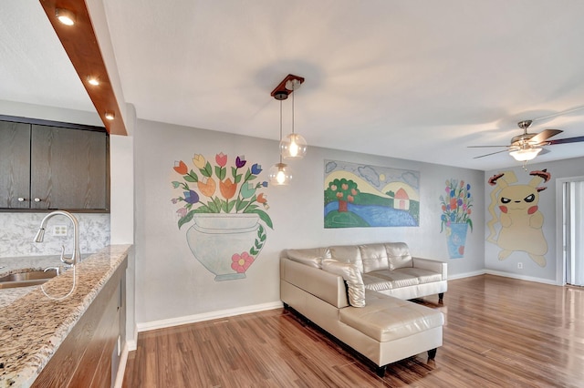 living room with sink, hardwood / wood-style floors, and ceiling fan