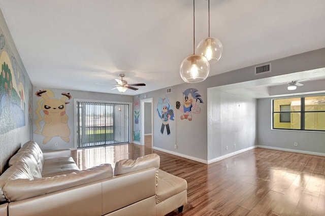 unfurnished living room featuring hardwood / wood-style floors and ceiling fan