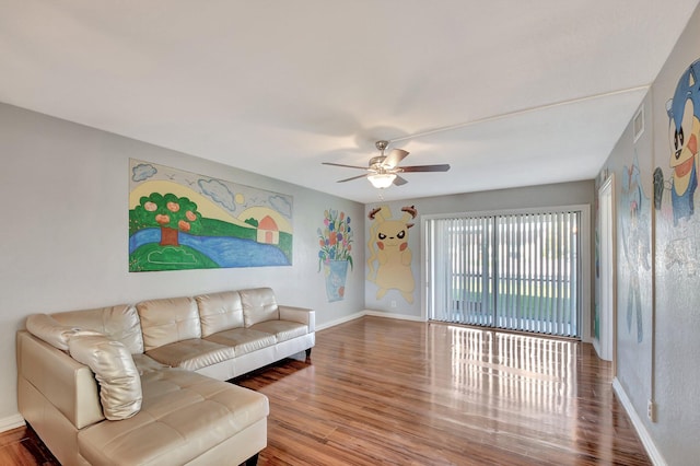 living room with hardwood / wood-style flooring and ceiling fan