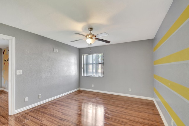 empty room featuring wood-type flooring and ceiling fan