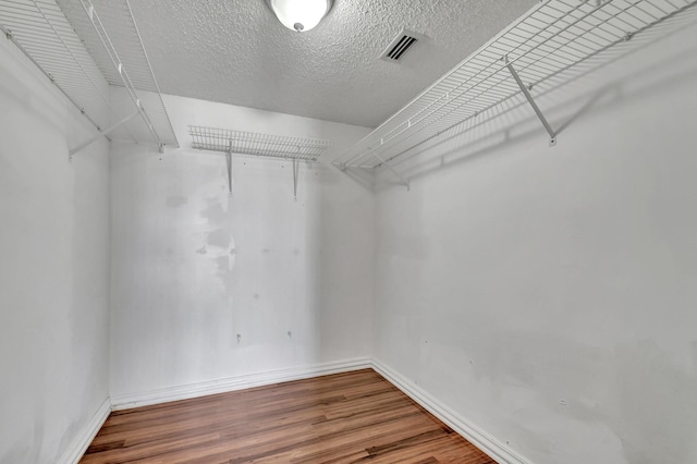 walk in closet featuring hardwood / wood-style flooring