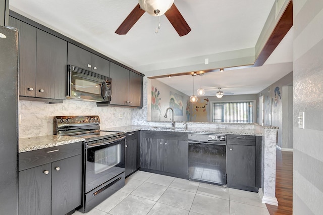 kitchen featuring decorative light fixtures, tasteful backsplash, black appliances, sink, and kitchen peninsula