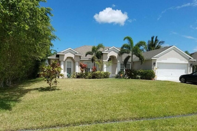 single story home with a garage and a front lawn