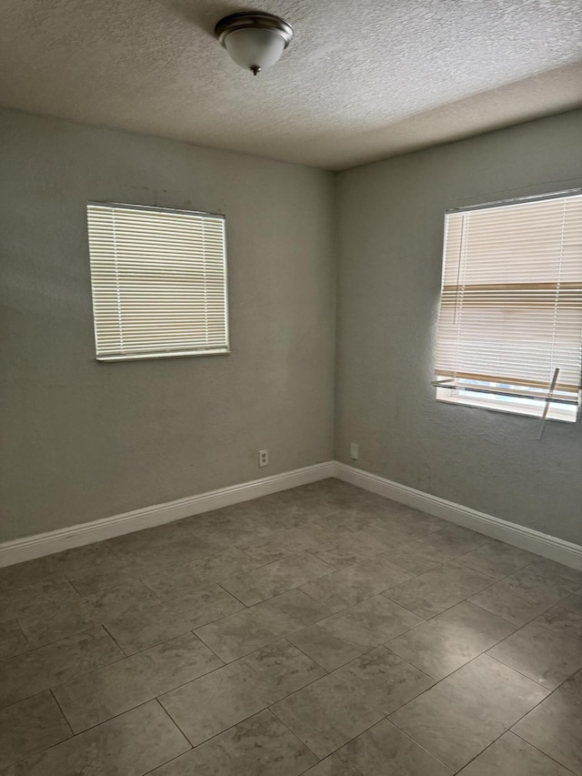 spare room with a textured ceiling