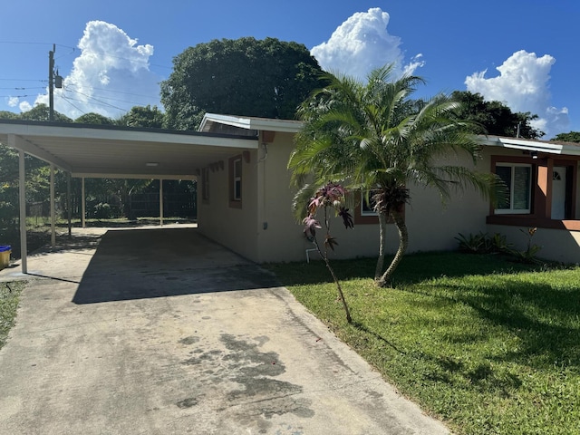 view of property exterior featuring a yard and a carport