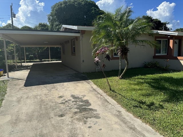 view of side of home with a lawn and a carport