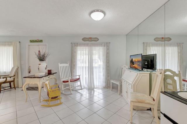 interior space with light tile patterned floors and a textured ceiling