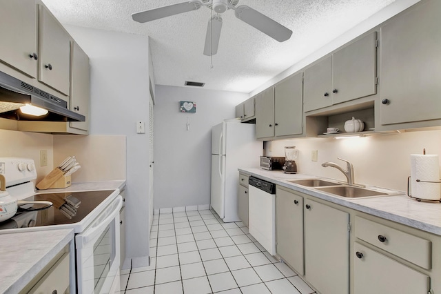 kitchen with white appliances, light tile patterned floors, a textured ceiling, ceiling fan, and sink