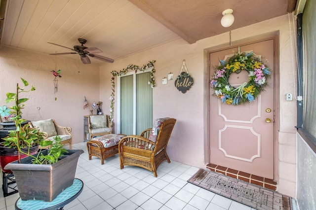 entrance to property with outdoor lounge area and ceiling fan