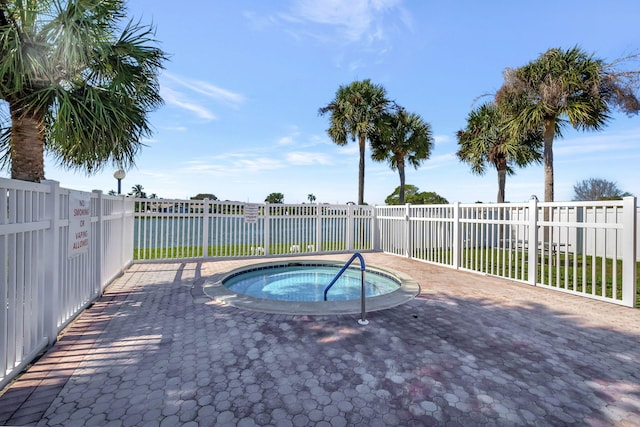 view of swimming pool with a patio and a hot tub