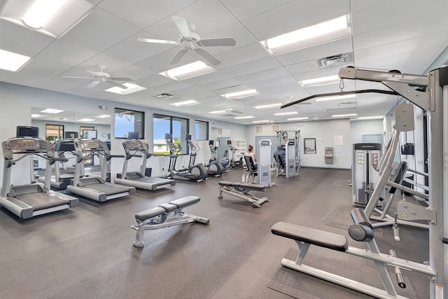 exercise room with a paneled ceiling and ceiling fan