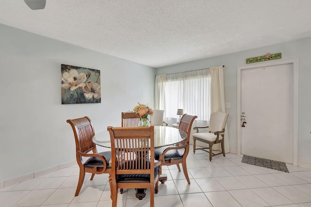 dining room with light tile patterned flooring and a textured ceiling